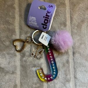 Claire’s “J” with charms and pom